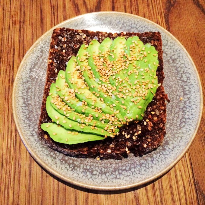Avocado toast on dark seeded rye, sesame seeds and flaky salt